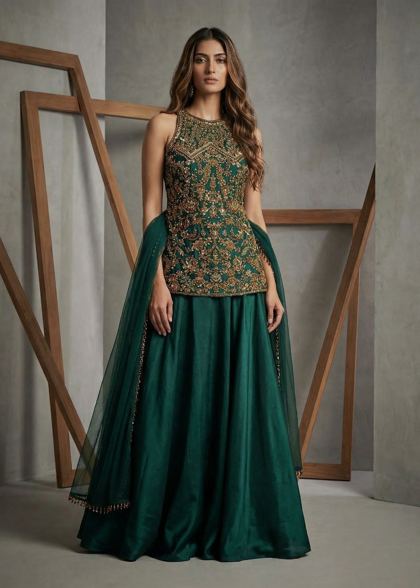 Woman wearing a green traditional outfit with floral top and long skirt against a neutral background