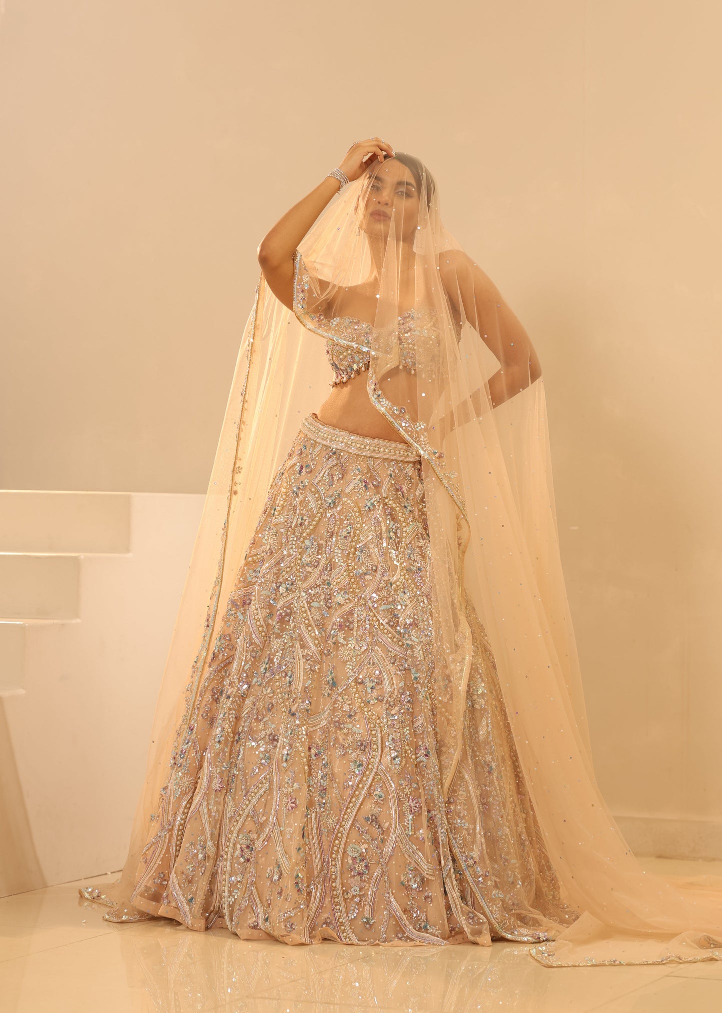 Gold dress with intricate patterns on a beige background