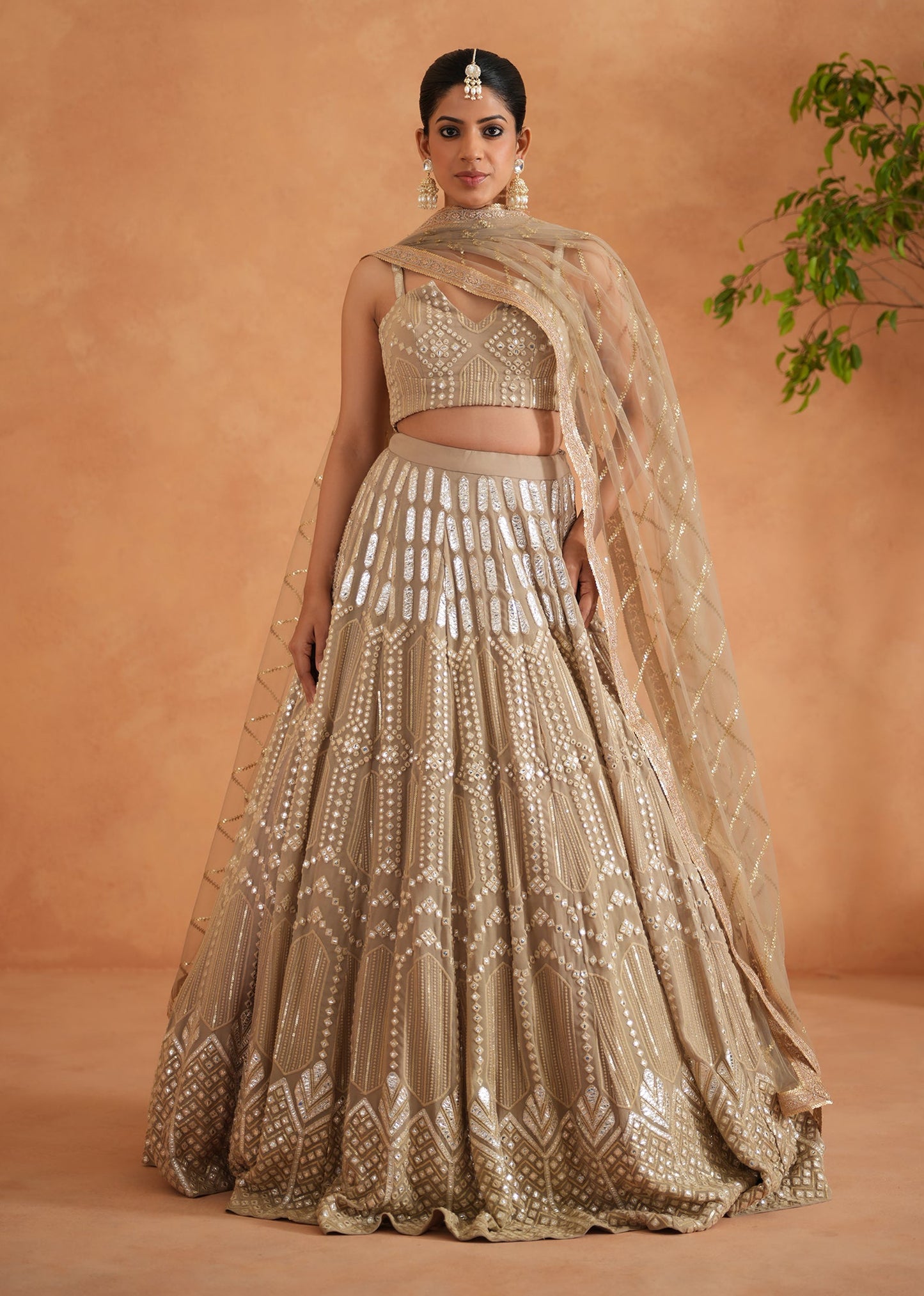 Woman in a traditional embroidered outfit against a warm-toned background