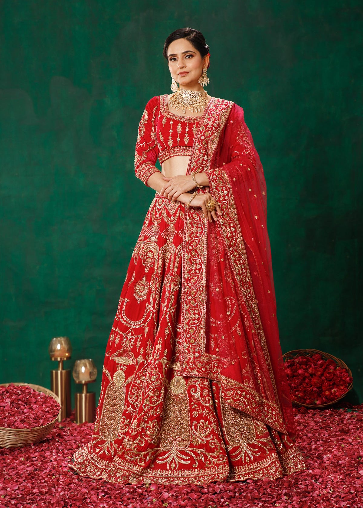 Woman in a red and gold traditional outfit standing on a green background with decorative elements.