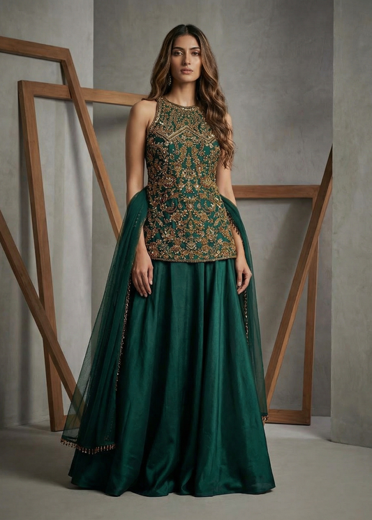 Woman wearing a green traditional outfit with floral top and long skirt against a neutral background