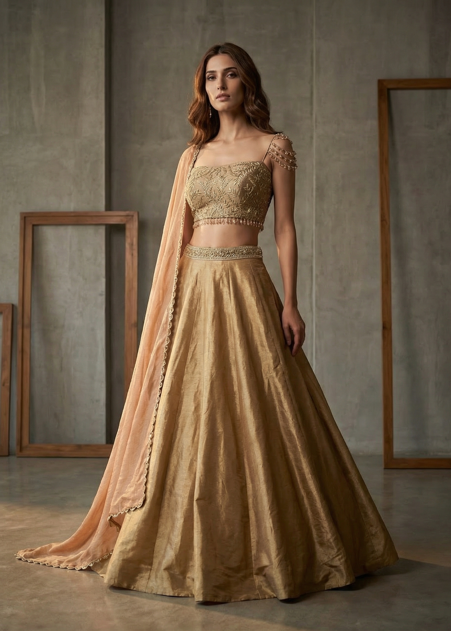 Woman wearing a traditional outfit with a gold top and skirt in a minimalistic setting.