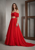 Woman wearing a red dress standing against a neutral background