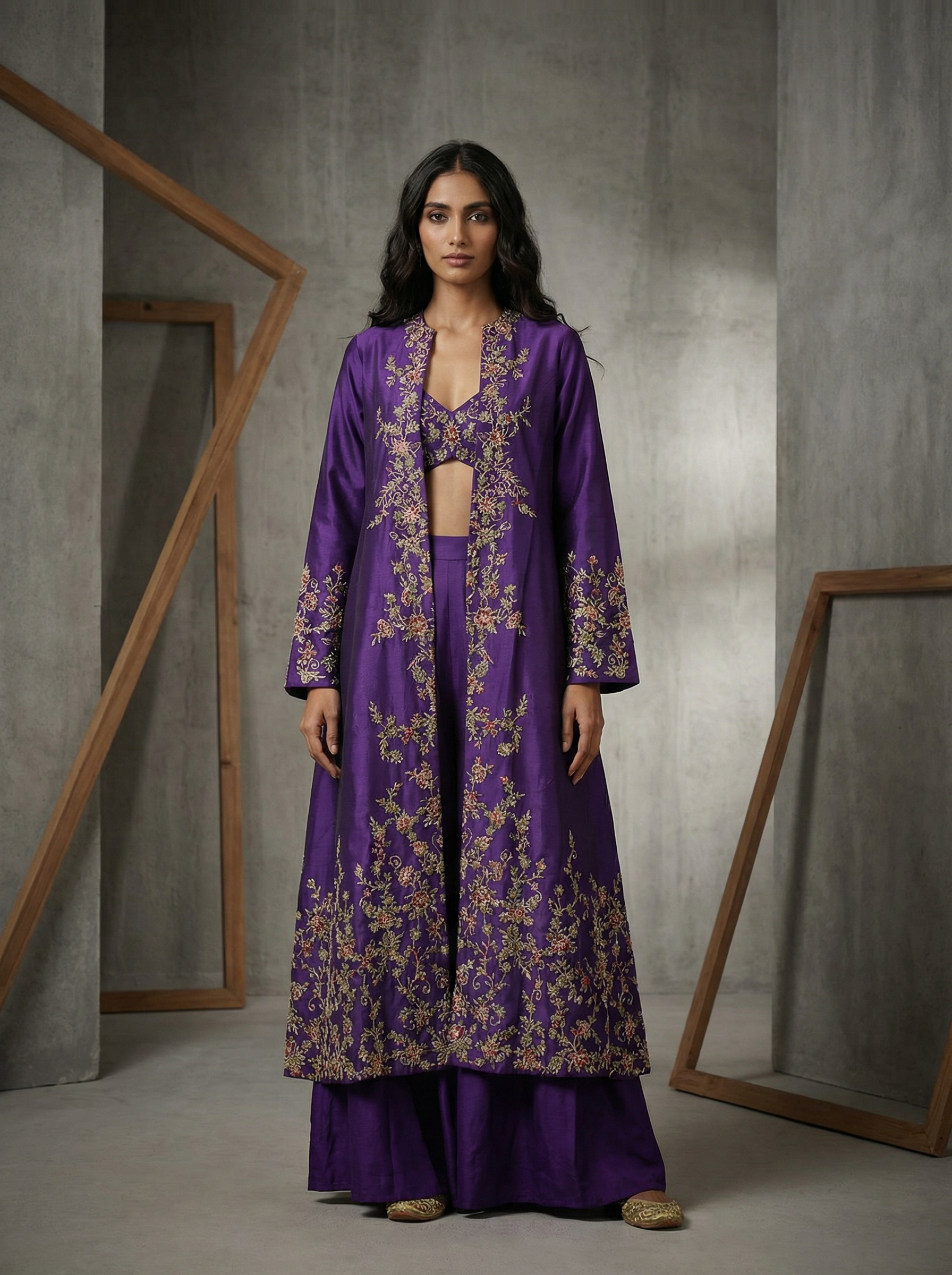 Woman wearing a purple embroidered outfit in a minimalistic setting
