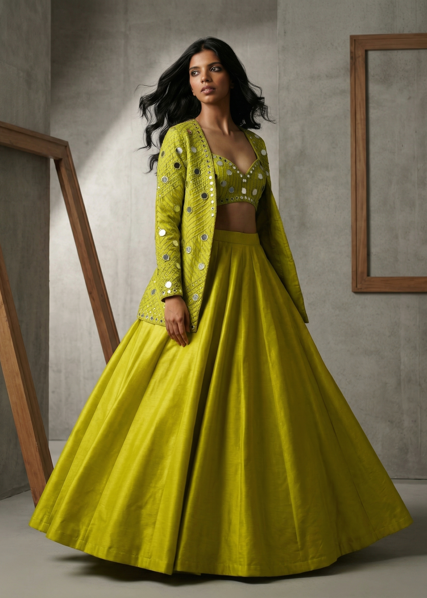 Woman wearing a bright yellow traditional outfit with a matching jacket against a neutral background.