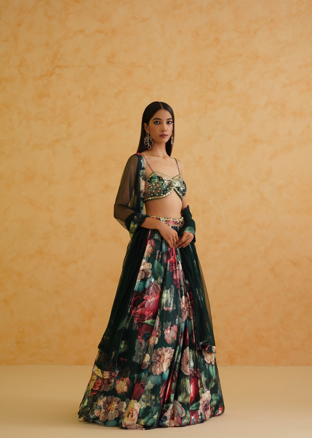 Woman wearing a floral outfit against an orange background