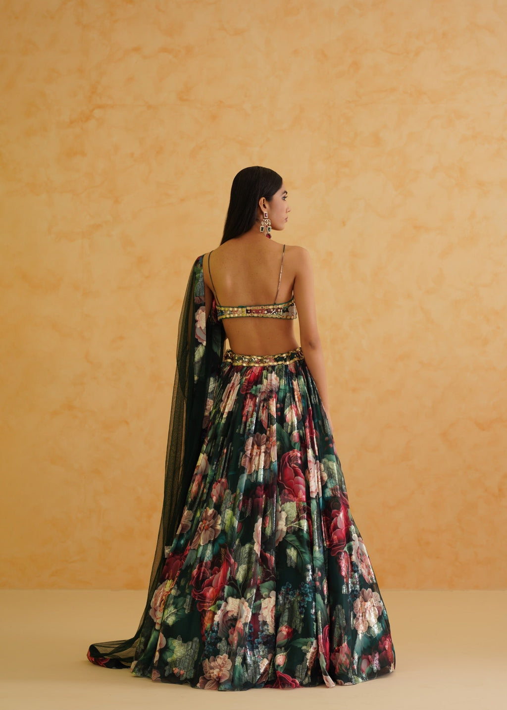 Woman wearing a floral dress with a plain background