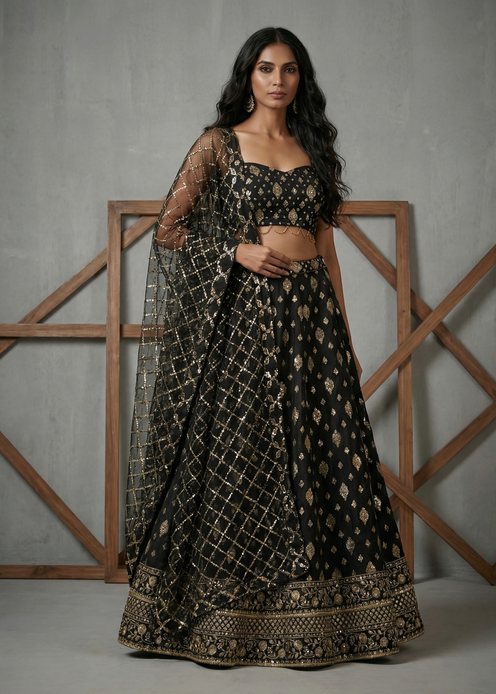 Woman wearing a black and gold traditional outfit with a gray background