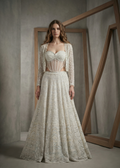 Woman wearing a detailed lace dress in a neutral setting