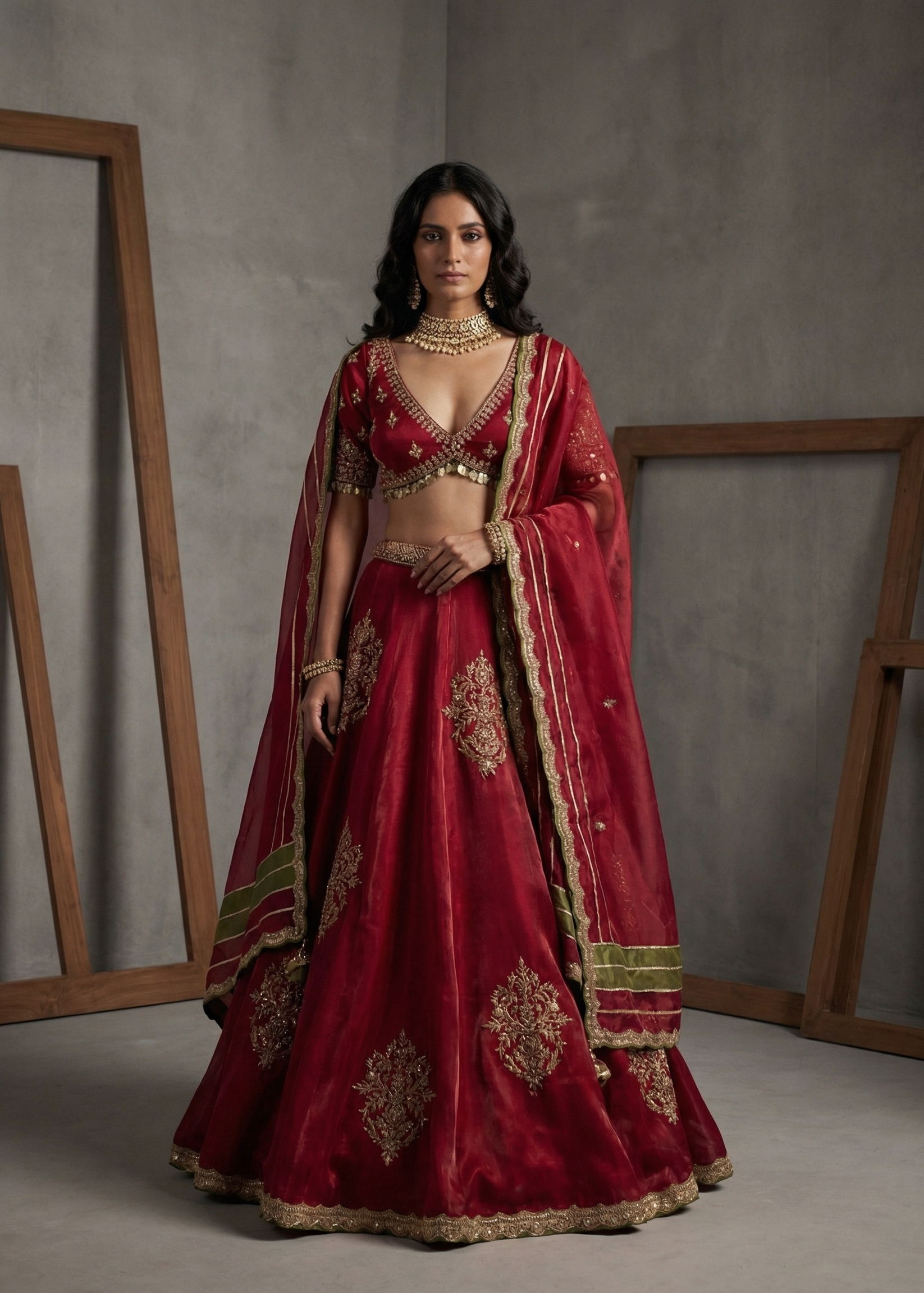 Woman in a red embroidered traditional outfit standing against a gray background