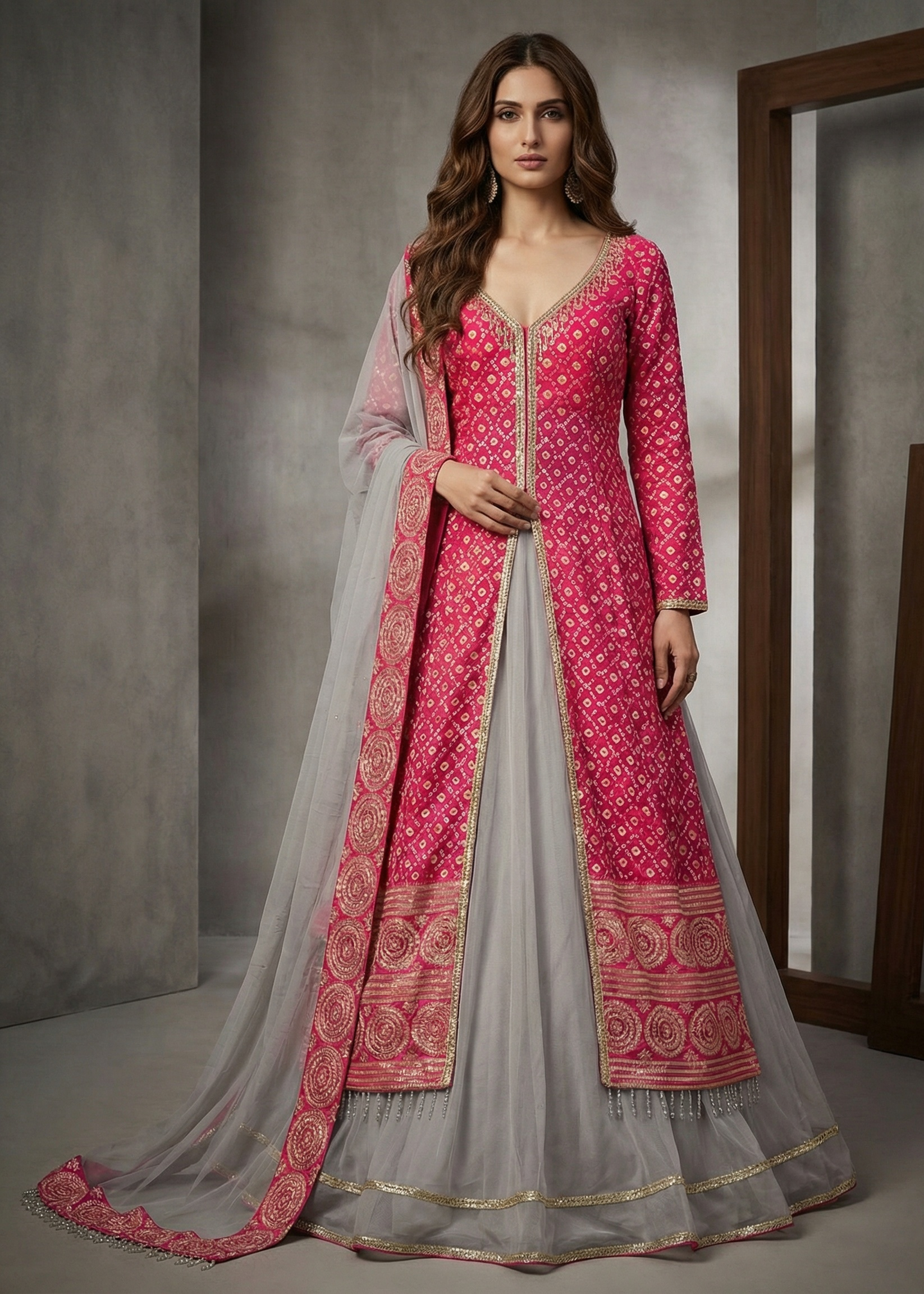 Woman wearing a pink and gray traditional outfit with intricate patterns.