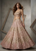Woman wearing a sparkling two-piece outfit in a room with geometric wall frames.