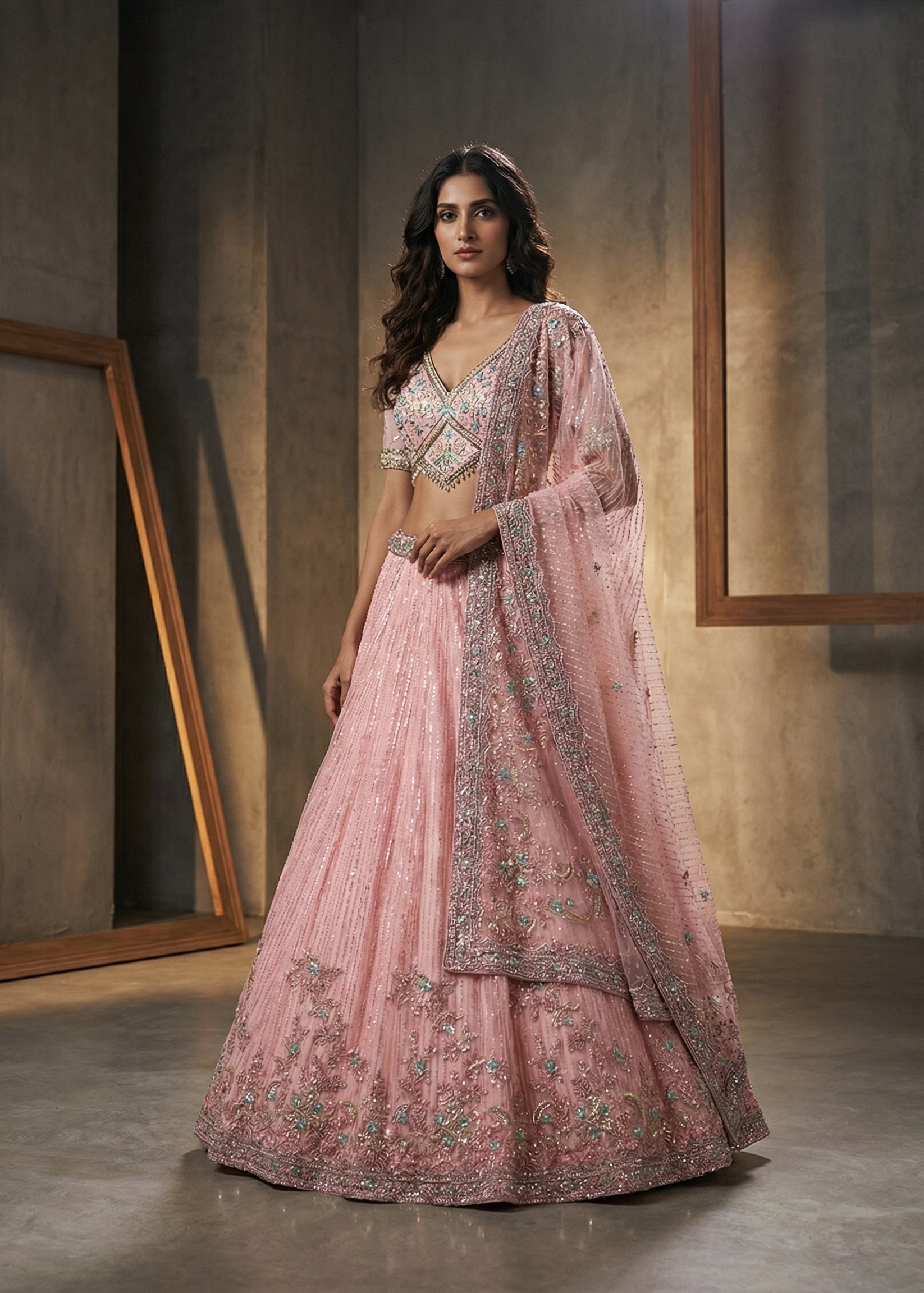 Woman in a pink embroidered traditional outfit standing against a neutral background