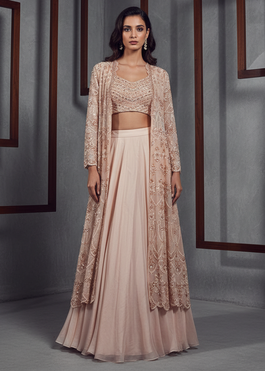 Woman wearing a beige embroidered outfit in a studio setting