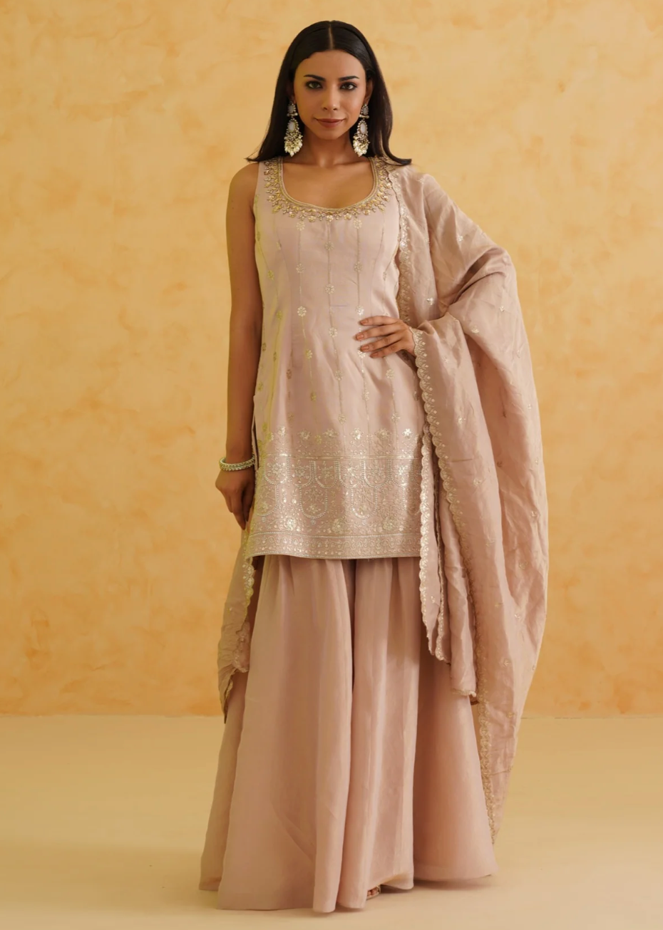 Woman wearing a traditional outfit with a beige background