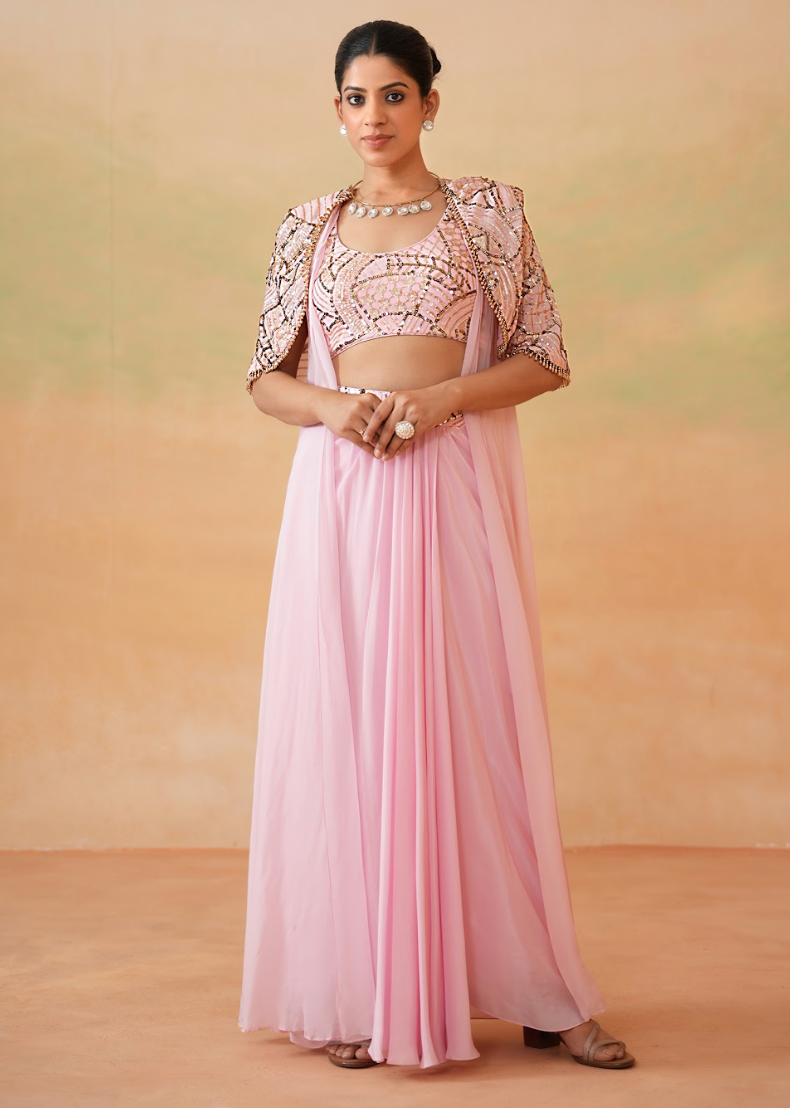 Woman wearing a pink traditional outfit with a beige background