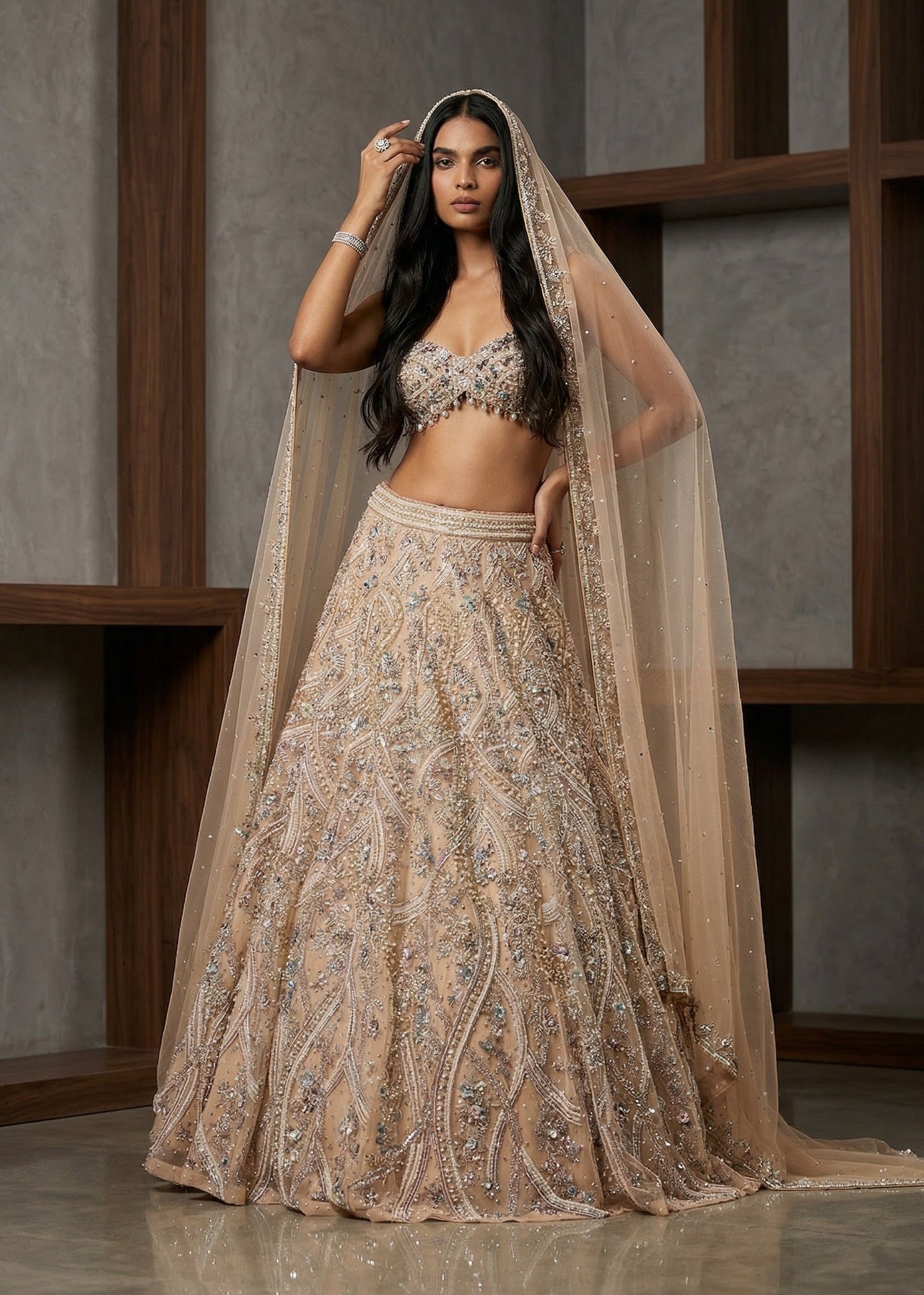 Woman in an elegant beige embroidered outfit with a matching dupatta against a neutral background